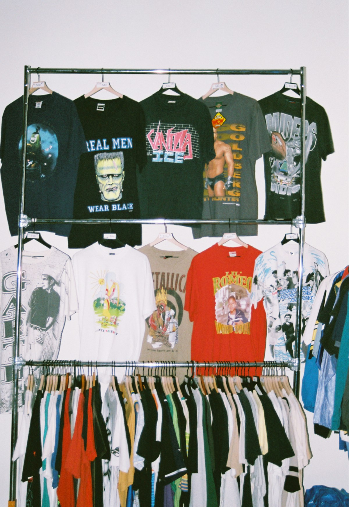 Rack of sorted vintage graphic tees ready for resale
